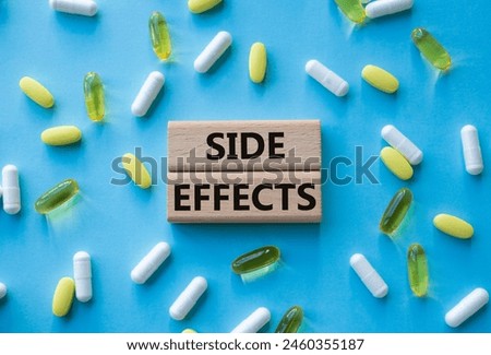 Side Effects symbol. Wooden blocks with words Side Effects. Beautiful blue background with pills. Medicine and Side Effects concept. Copy space.
