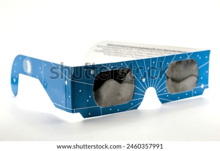 eclipse glasses (disposable paper nd filters for looking at the sun during solar events) isolated on white background shades eye protection from bright light uv