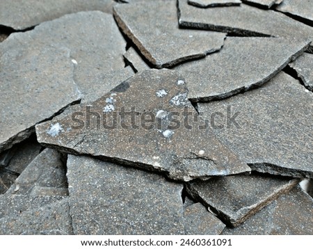 Natural stone chips typically refer to small pieces of stone that are often used in landscaping, construction, or decorative purposes. Royalty-Free Stock Photo #2460361091
