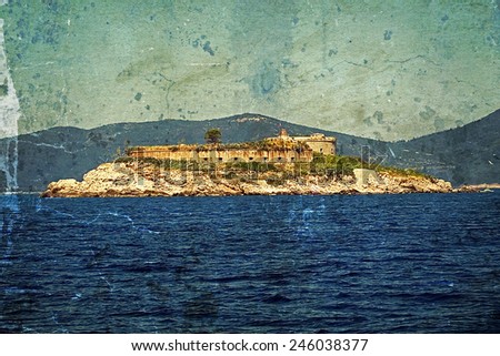 Old photo with a medieval fortress on the coast of Dalmatia, Adriatic Sea. Montenegro, Europe.Image digitally manipulated in the form of old photos.