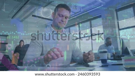 Image of financial data processing over caucasian man using smartphone at office. Global finance and business technology concept