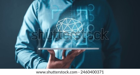 ai, iot, brain, future, human, intellect, intelligence, learning, mental, mind. A man is holding a tablet with a brain image on it. The image is blue and white and has a futuristic feel to it.