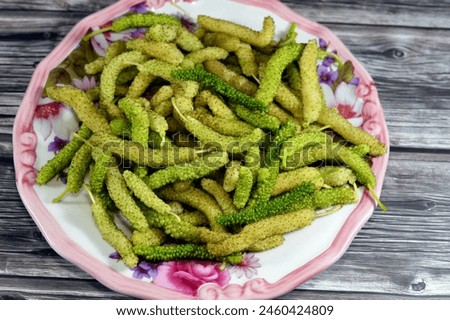 White Shahtoot Mulberry fruits, Long Morus nigra or alba edible fruit, Called also toot, superior mulberries, Morus is a genus of 10–16 species of trees, native to warm regions of Asia and Africa Royalty-Free Stock Photo #2460424809