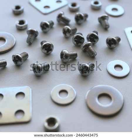 Variety Metal Steel Fastener And Fixing Items Scattered On Scratched Surface Square Stock Photo. Ironware Goods Royalty Free Background
