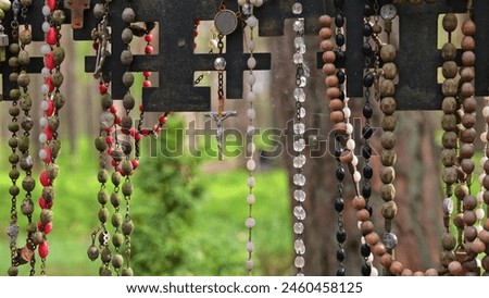 Prayer Rosaries Made of Wood Pearl Glass Hanged by Pilgrims at Christian Worship Place as Votive Offering Royalty-Free Stock Photo #2460458125