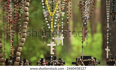 Prayer Rosaries Made of Wood Pearl Glass Hanged by Pilgrims at Christian Worship Place as Votive Offering Royalty-Free Stock Photo #2460458127