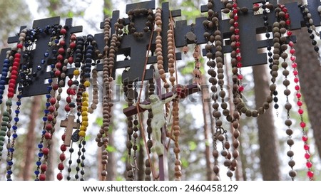 Prayer Rosaries Made of Wood Pearl Glass Hanged by Pilgrims at Christian Worship Place as Votive Offering Royalty-Free Stock Photo #2460458129
