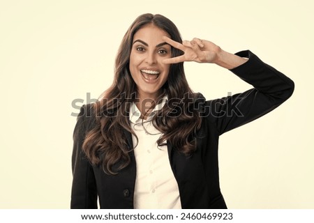 Business woman with victory sign. Happy positive funny businesswoman show victory v-sign gesture isolated on white background, studio portrait. Portrait of attractive funny crazy student.