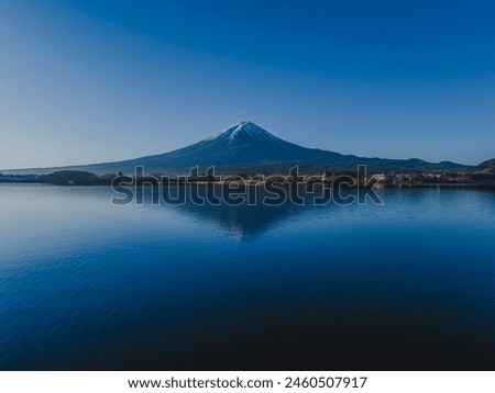 Mt. Fuji on a clear day_Snow-capped_Over Lake Kawaguchi_Drone aerial photography