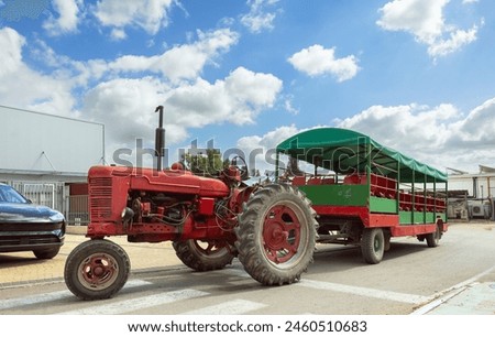 Old tractor with trolley for transporting people through the countryside