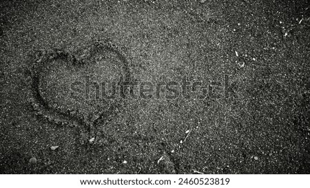 Love sign on black sand on the beach
