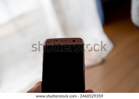 Hand of person holding smartphone