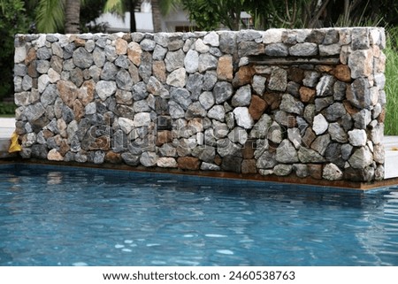 Phuket, Thailand, Asia - 06 30 2011 : Exterior photo view of a swimming pool of a holiday vacation resort hotel with wall elements equipments