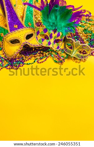 A venetian, mardi gras mask or disguise on a yellow background