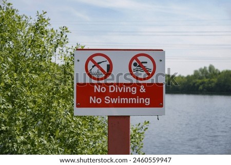 Water safety sign for public at lakeside. No swimming or diving allowed in lake. 