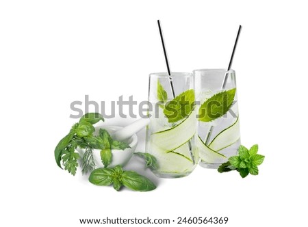 Invigorating lemon juice complemented by the invigorating aroma of fresh mint leaves and slices of tangy lemon. Royalty-Free Stock Photo #2460564369