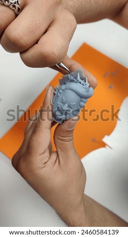 3d printing in progress, 3d printed of a cartoon man figure close-up