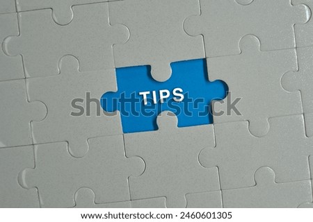 Piece of jigsaw puzzle with words TIPS.
