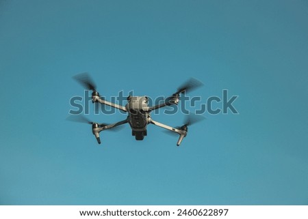 The UAV drone and photographer man hands. drone copter flying with digital camera. UAV Drone with digital camera. Flying camera take a photo and video. The drone with camera takes pictures of the sky.
