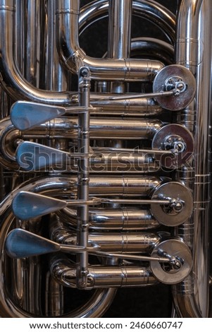 Rotary valves and linkages on a tuba. Royalty-Free Stock Photo #2460660747