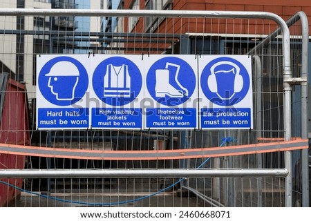 Construction site health and safety sign on fence