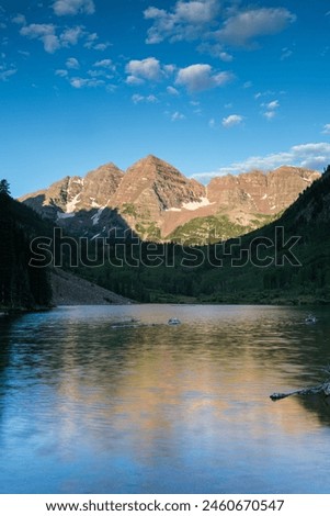 A still morning reflection of the Maroon Bells that are located in the Maroon Bells Snowmass Wilderness Area of Central Colorado. Royalty-Free Stock Photo #2460670547