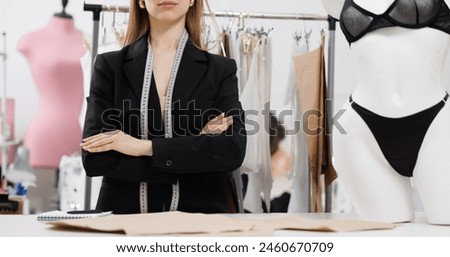 Portrait of young woman fashion designer at workplace of sew factory, concept of sewing exclusive underwear.