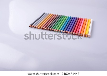 Color Pencils of Various colors placed on white background
