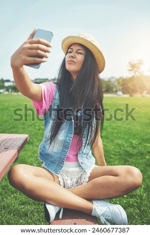 Funny face, girl and selfie on bench in park for profile picture on social media or memory of summer vacation in California. Woman, sunshine and holiday with photography or blog for content creation.
