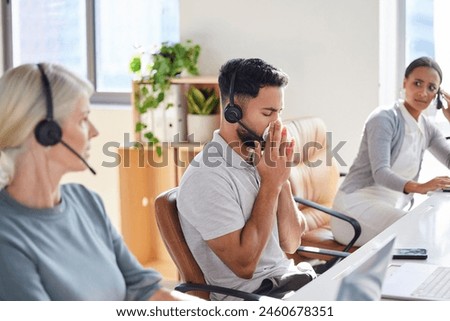 Man, sick and coworkers in call centre office or blowing nose with unhappy colleagues, telemarketing or flu. Male person, headset and customer service or with cold symptoms, contagious or illness Royalty-Free Stock Photo #2460678351
