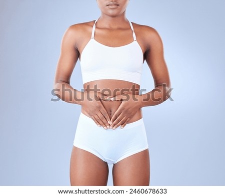 Stomach, heart hands and woman with underwear, wellness and healthy gut on blue studio background. Person, mockup space or model with sign for love, icon and protein with fitness, fiber and digestive
