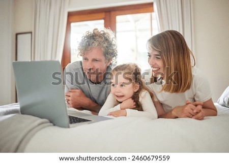 Child, parents and relax with laptop on bed, house and bonding, watching movie or streaming online for entertainment. Family, girl and together on internet with care, subscription or cartoon film