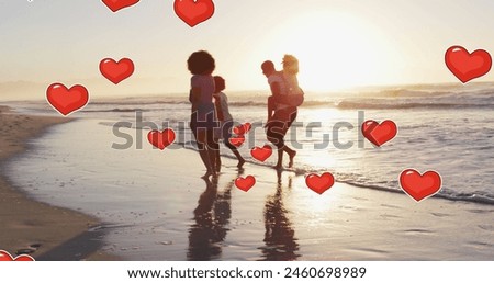 Image of hearts over african american family at beach. social media and communication interface concept digitally generated image.