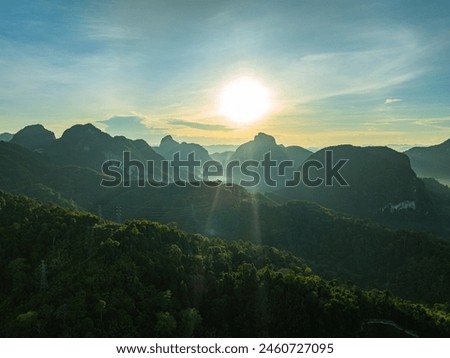 aerial hyper lapse view Amazing light of nature cloudscape above mountain range in Phang Nga. 
High peaks wonderful morning sunset natural Landscape. 
Beautiful sunset tropical landscape background.
