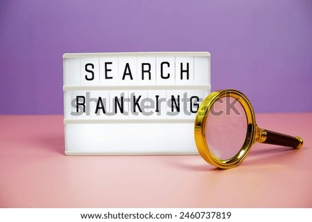 Search Ranking letterboard text on LED Lightbox and magnifying glass on pink and purple background