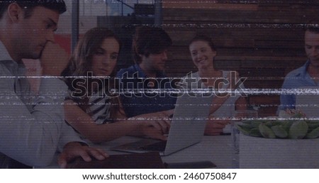 Image of screen with glitch over diverse female and male coworkers in office. Business, network, web development and data processing concept digitally generated image.
