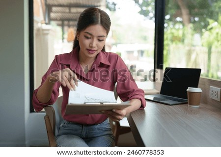 Happy Asian businesswoman on balcony using laptop to do morning work Business woman on holiday working outside that is natural Beautiful blogger woman thinking about content for work.