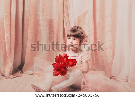 Adorable little girl dressed as a ballerina in a tutu indoor