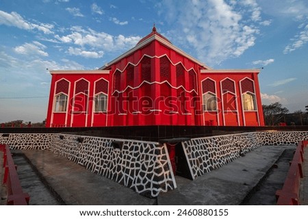 Red mosque with cloudy blue sky background