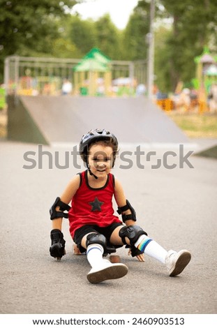 Cute kid girl child with skateboard isitting in a skatepark and smiling. Child performs tricks. Summer sport activity concept. Happy childhood.