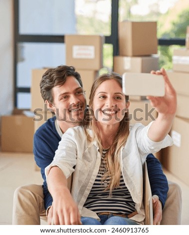 Happy couple, relax and moving in with selfie for photography, new home or picture at apartment. Young man and woman with smile or playing in box for memory in house, investment or property together