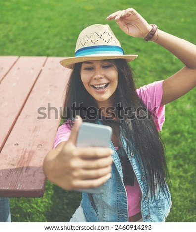 Happy, girl and selfie on bench in park for profile picture on social media or memory of summer vacation in California. Woman, sunshine and holiday with photography or pose with hat and relax.