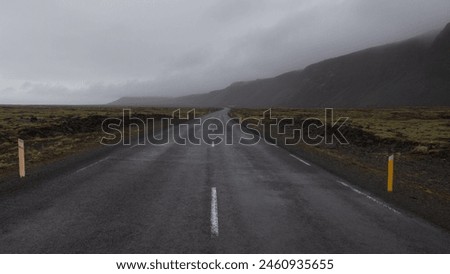 Road through the Icelandic countryside with dramatic weather in winter Royalty-Free Stock Photo #2460935655