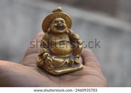 Laughing Buddha on Palm to bring smile on face. raw photo