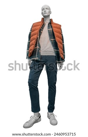 Full-length male mannequin dressed in stylish checkered shirt, orange vest, navy blue trousers and white gumshoes isolated on white background with clipping path Royalty-Free Stock Photo #2460953715
