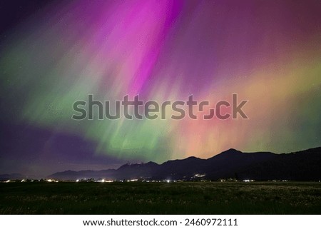 Radiant beams of green and purple light dance across the night sky above the Cheam Mountain Range in Chilliwack, BC. 
