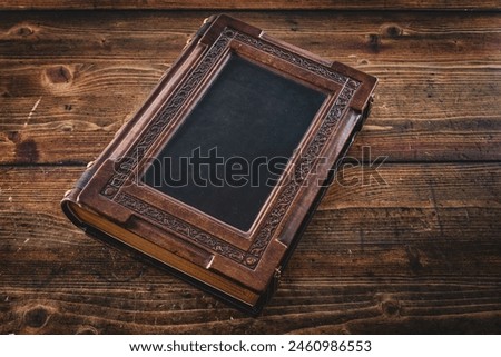 Weathered leather book lay down to wooden table