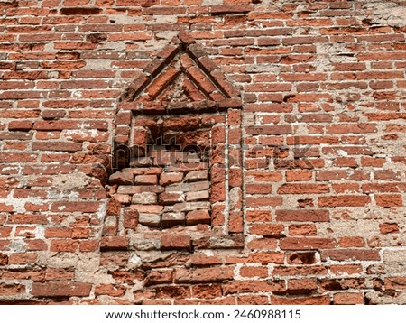 an ancient loophole laid with bricks Royalty-Free Stock Photo #2460988115