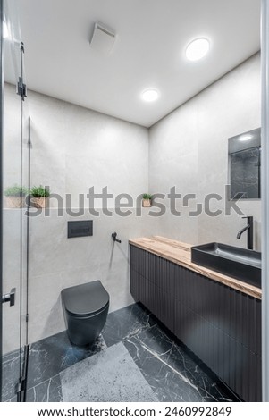 Interior of Luxury chromed shower in modern marble bathroom. Spacious bathroom in gray tones with heated floors. Furniture, sink, shower. Marble.