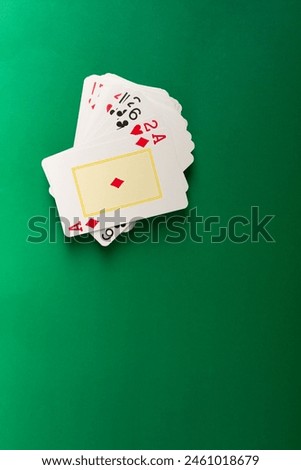 Playing cards for poker and gambling, isolated on green background.